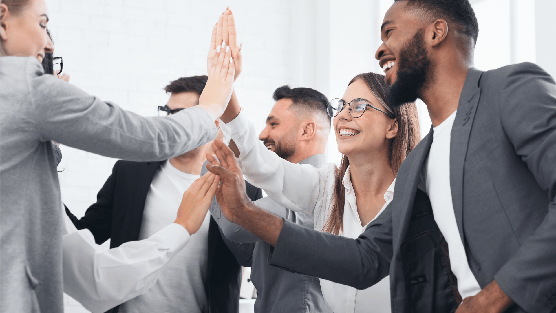Employees high-fiving in the office