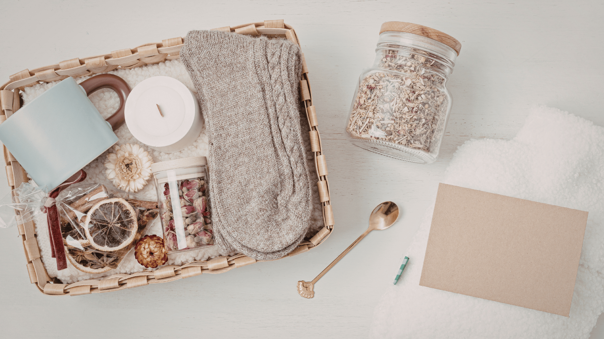 Self-care package with oats, fruits, socks, candles, and more