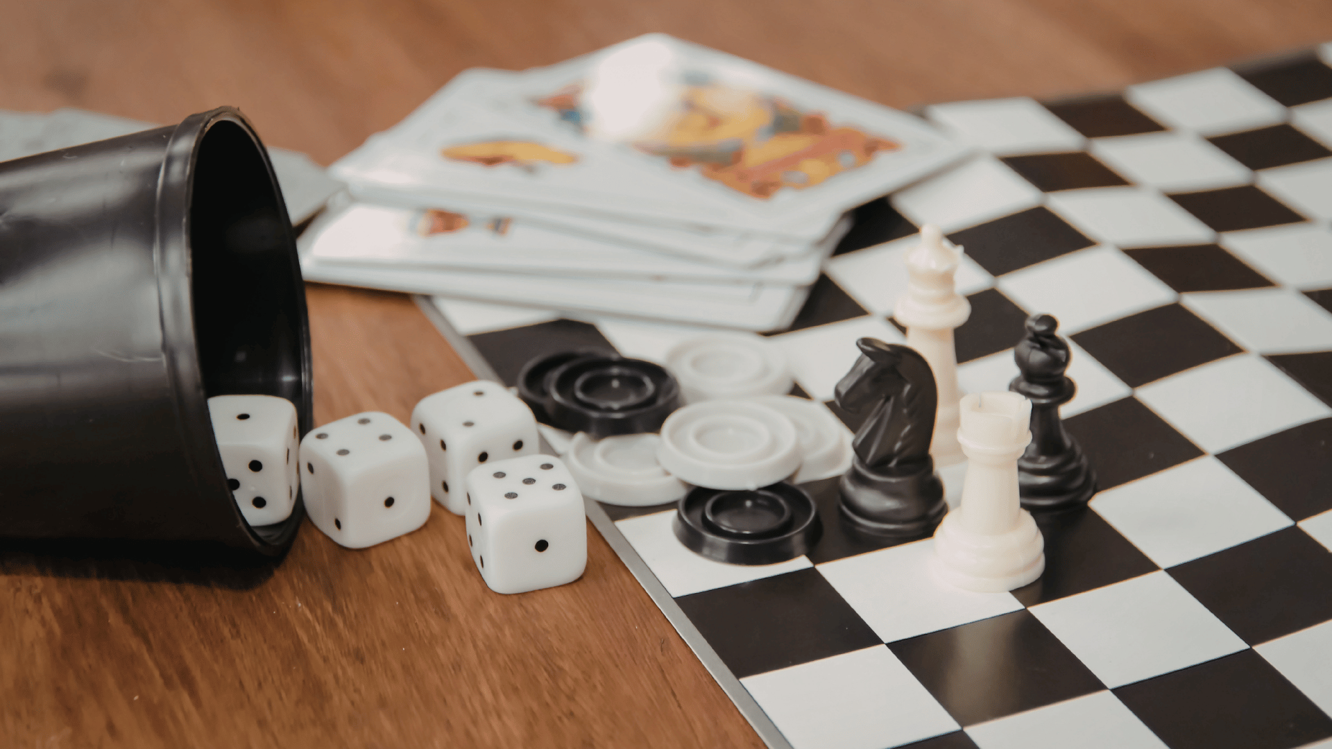 Table with chess, checkers, playing cards, and Yahtzee on it