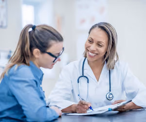 Female doctor speaking to female patient