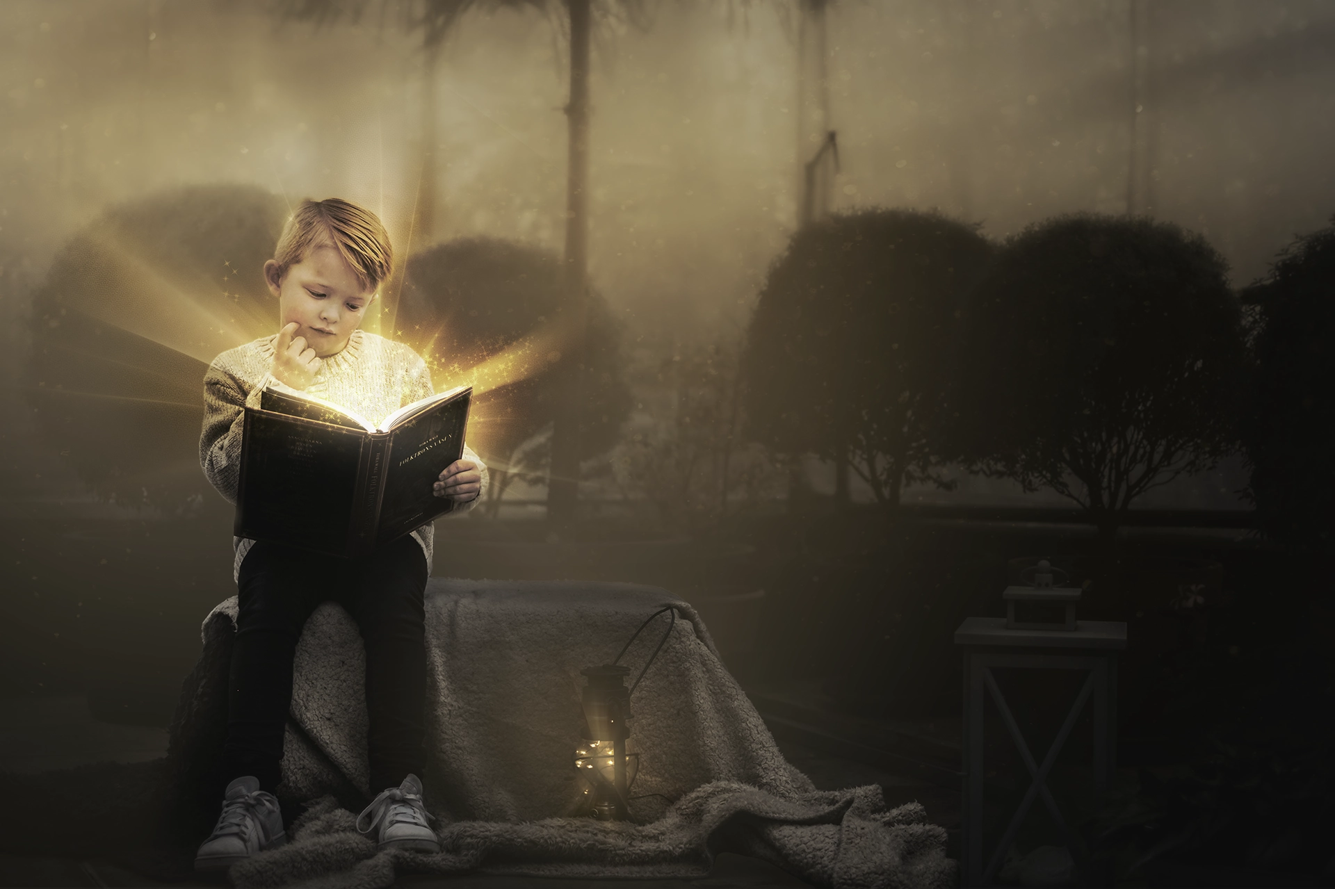 Ett barn som öppnar en sagobok varifrån ljus strålar. Sagolik fotografering inför julen 2025.