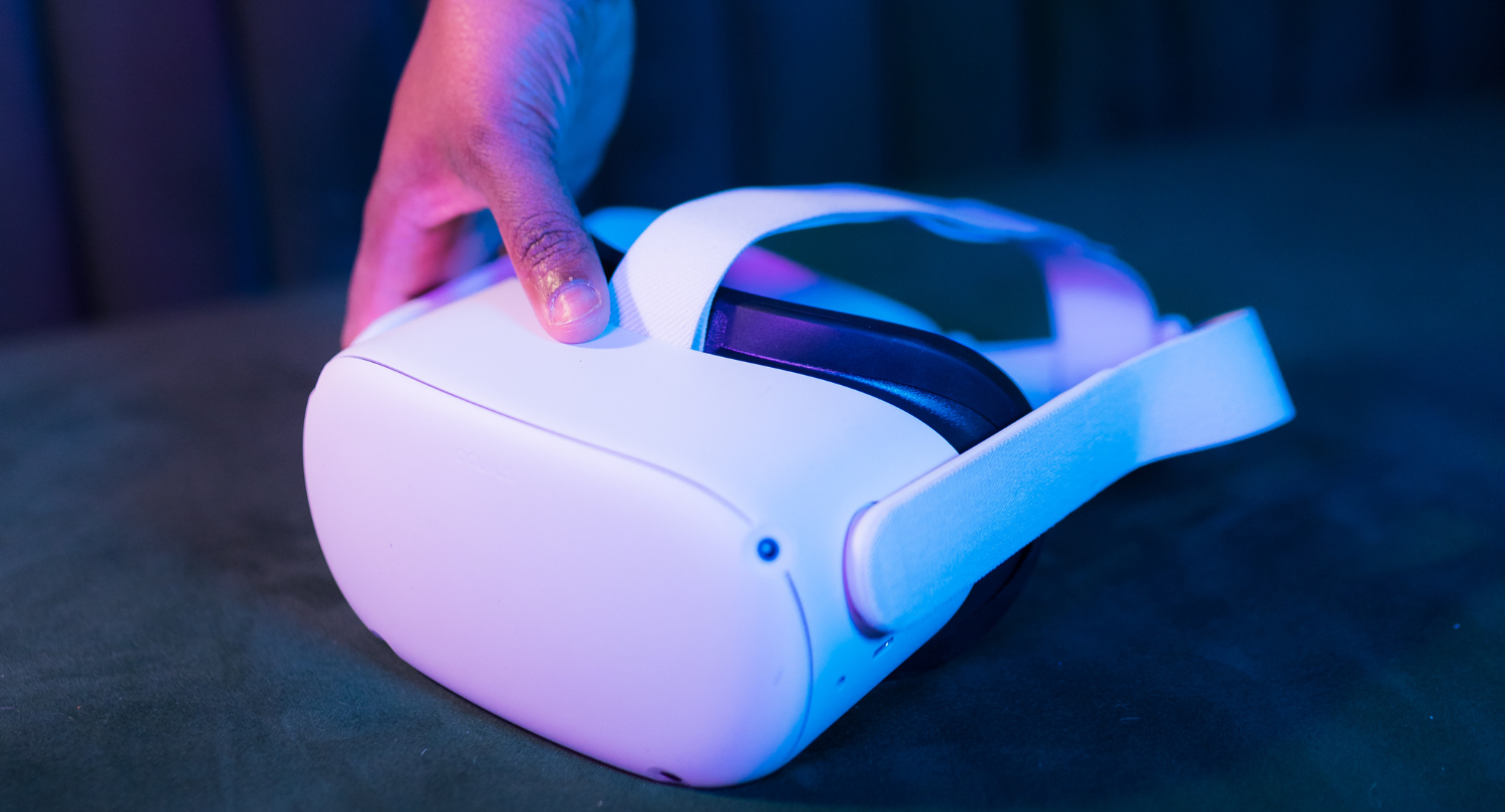A hand holding a VR headset 