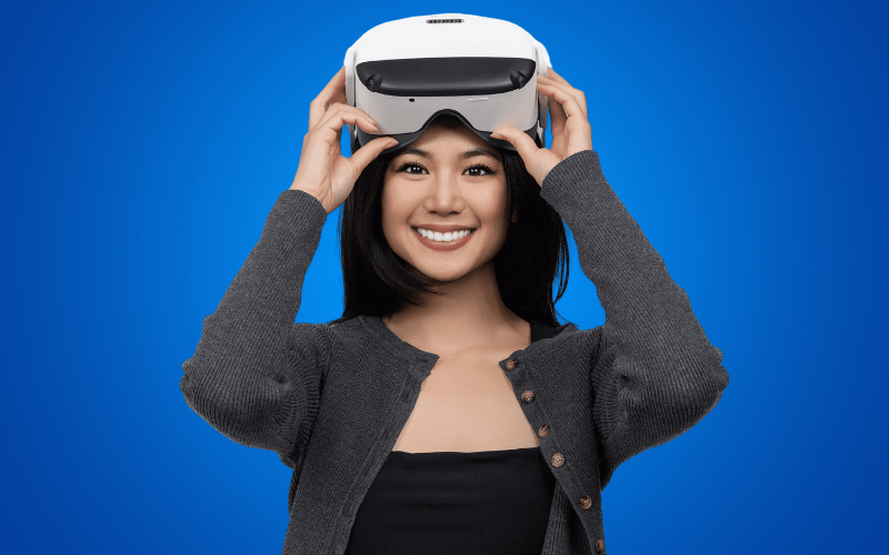 Woman against a blue background placing a Virtual Field on her head