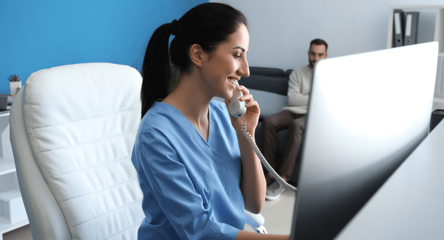 Happy office receptionist talks on the phone