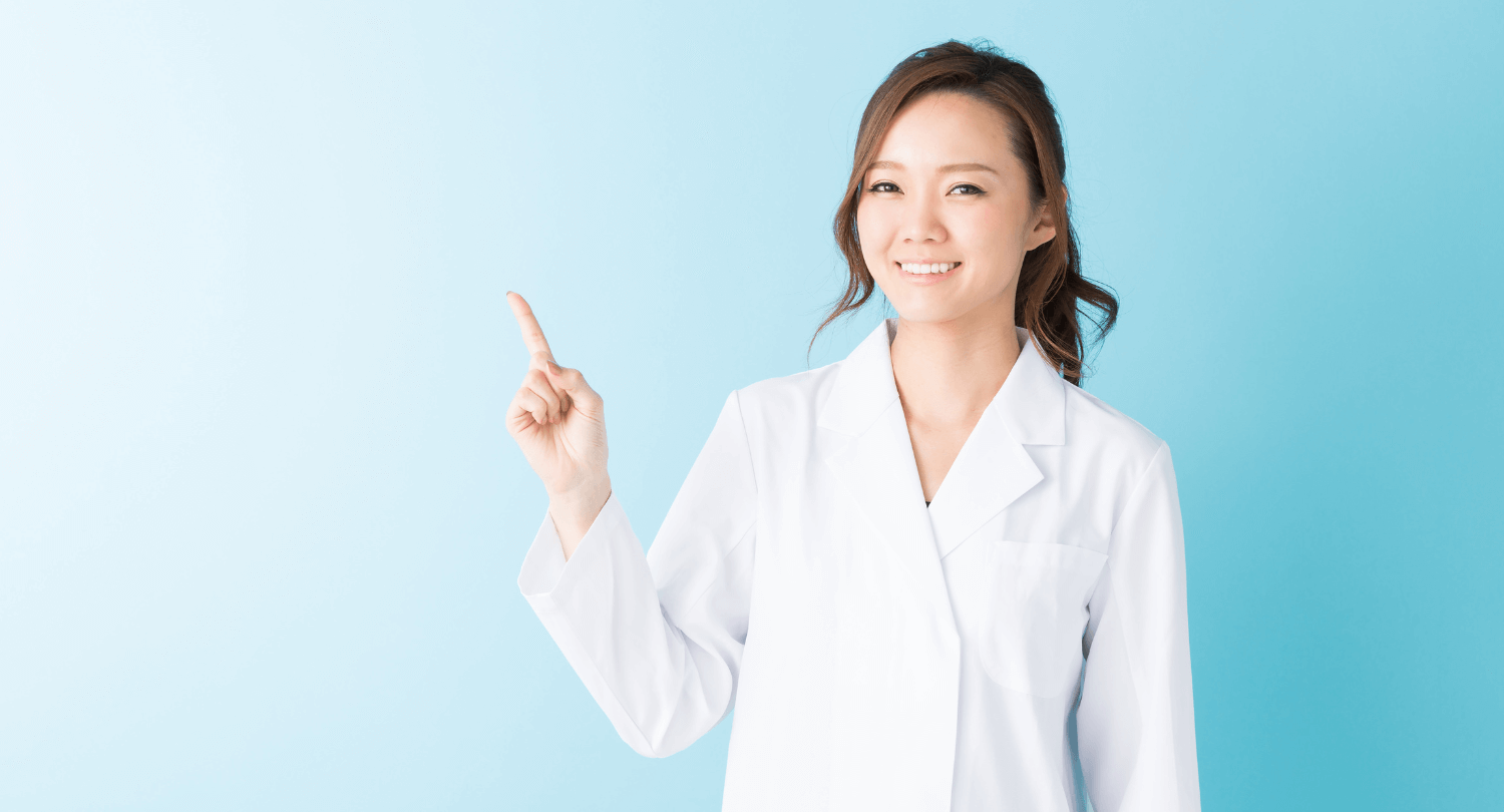 Smiling eye doctor against blue background