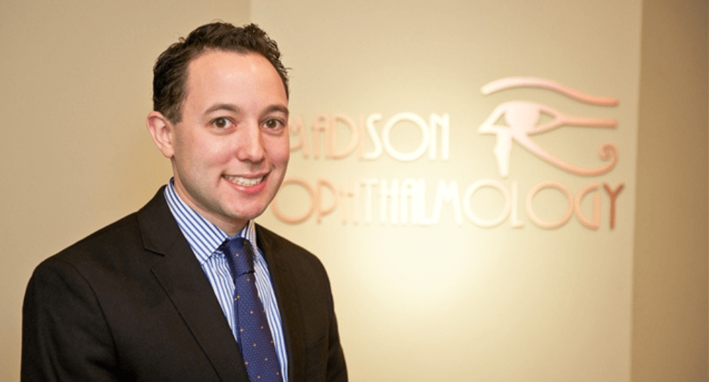 Dr. Kahn stands in front of the interior entrance to his practice
