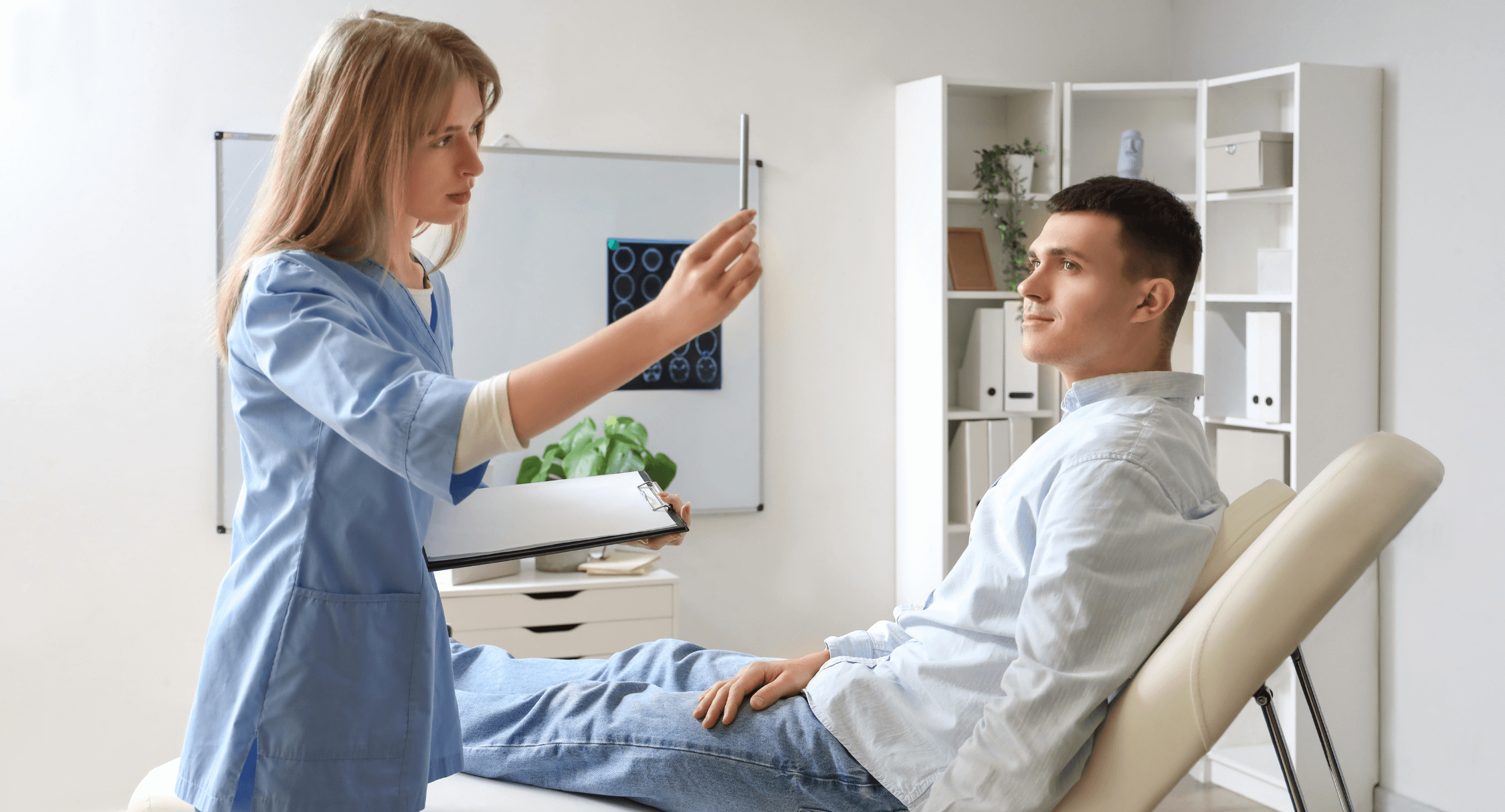 An eye doctor performs a confrontation test on a young man sitting on an exam table