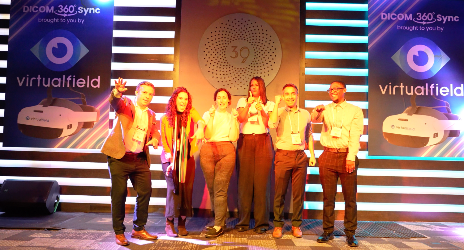 Virtual Field employees stand on stage at the DICOM 360 Sync launch party.
