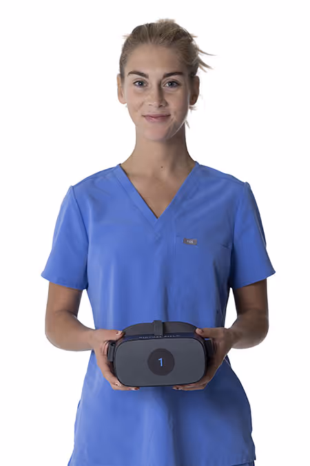 A technician in blue scrubs holding a Virtual Field