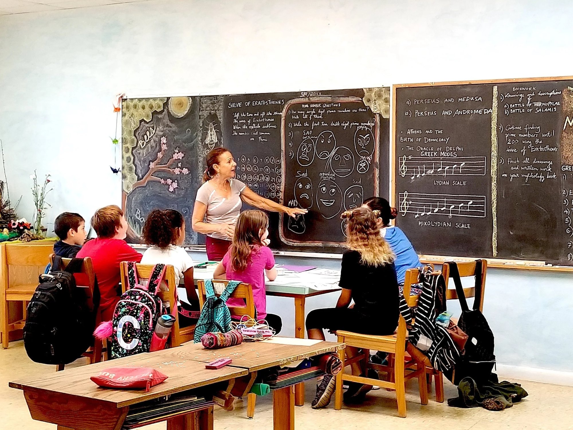 Teacher at a chalkboard with students at the Waldorf School of Palm Beach