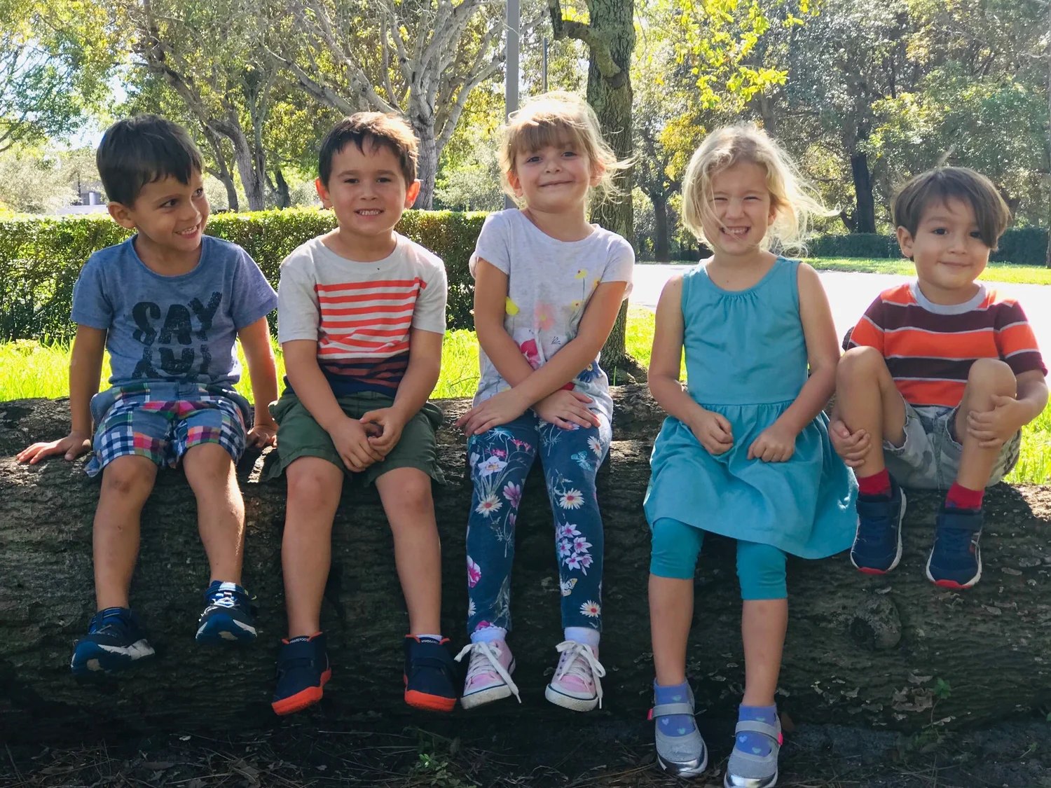 Five Waldorf School of Palm Beach students sitting together outdoors