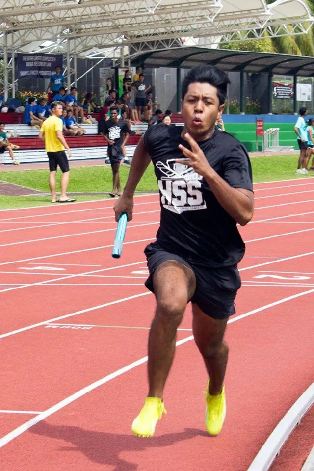 a man running on a track, displaying the event identity