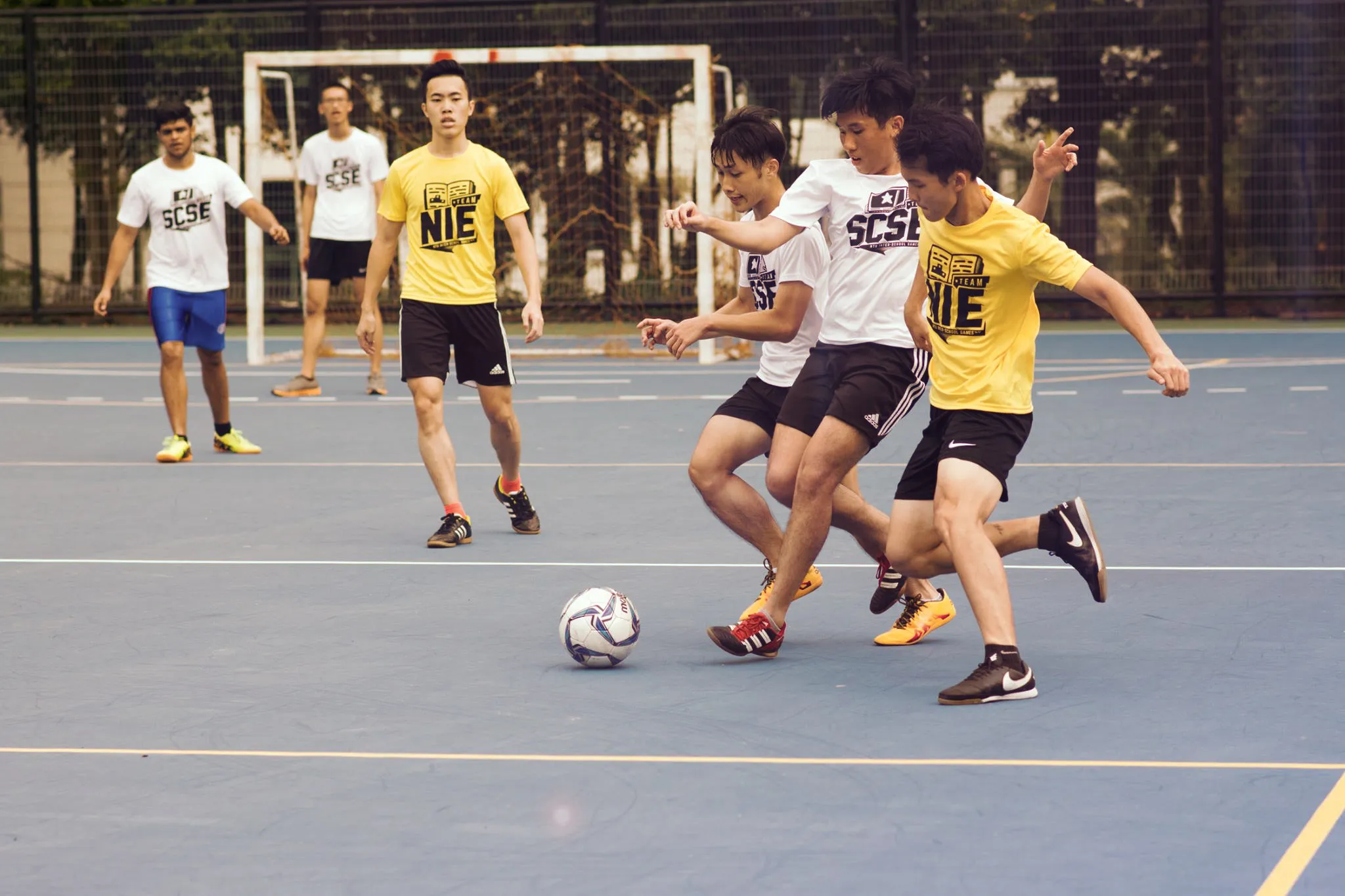 A Futsal match going on with participants wearing the event identity