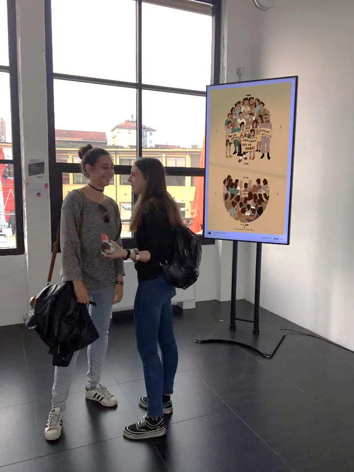 two women standing next to each other in front of a poster