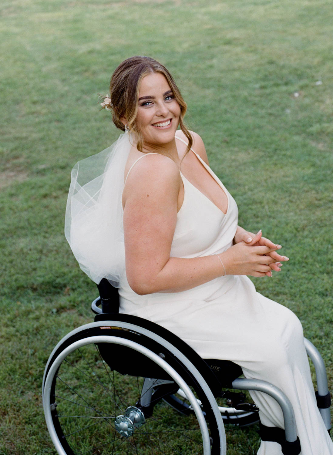 Bride in a wheelchair smiling at the camera