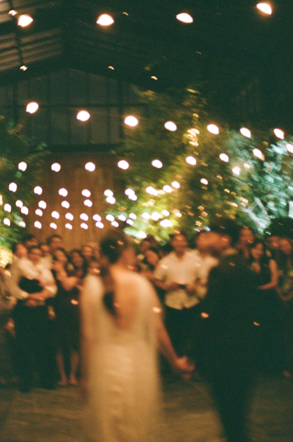 Blurry analog dance floor photo of bride and groom at Glasshouse Morningside