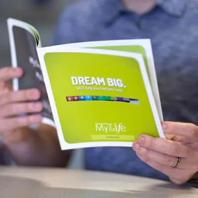 printing services - man holding booklet