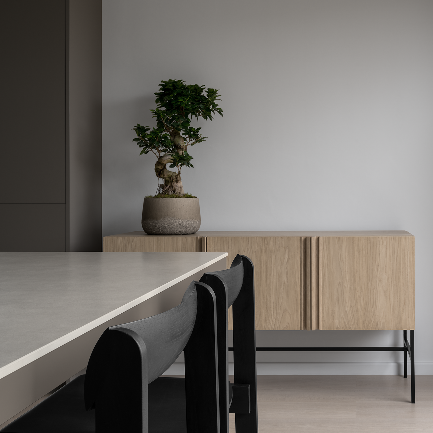 Modern Japanese minimal dining room with bleached oak floor, white walls, sintered stone dining table, black Scandinavian wood dining chairs, oak sideboard and bonsai tree