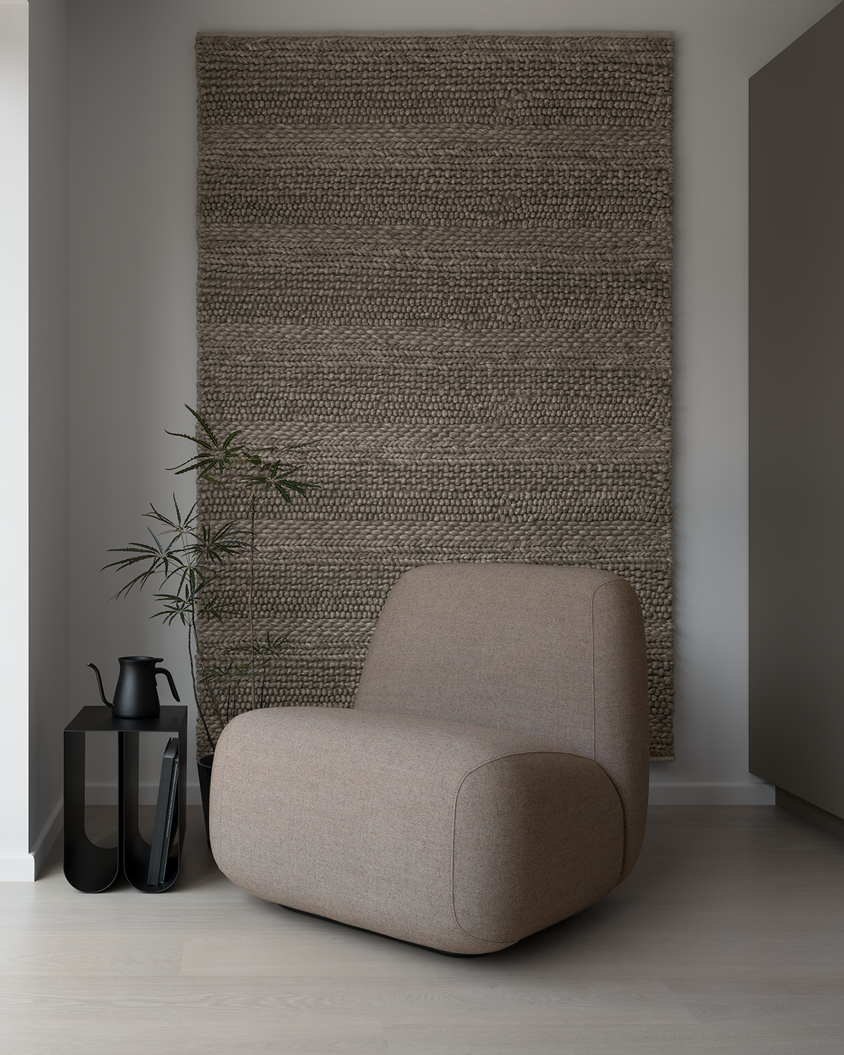 Modern minimal Japanese living room with Scandinavian lounge chair on bleached oak floor with black metal side table, black coffee pot, Plerandra elegantissima plant against a grey brown wall rug