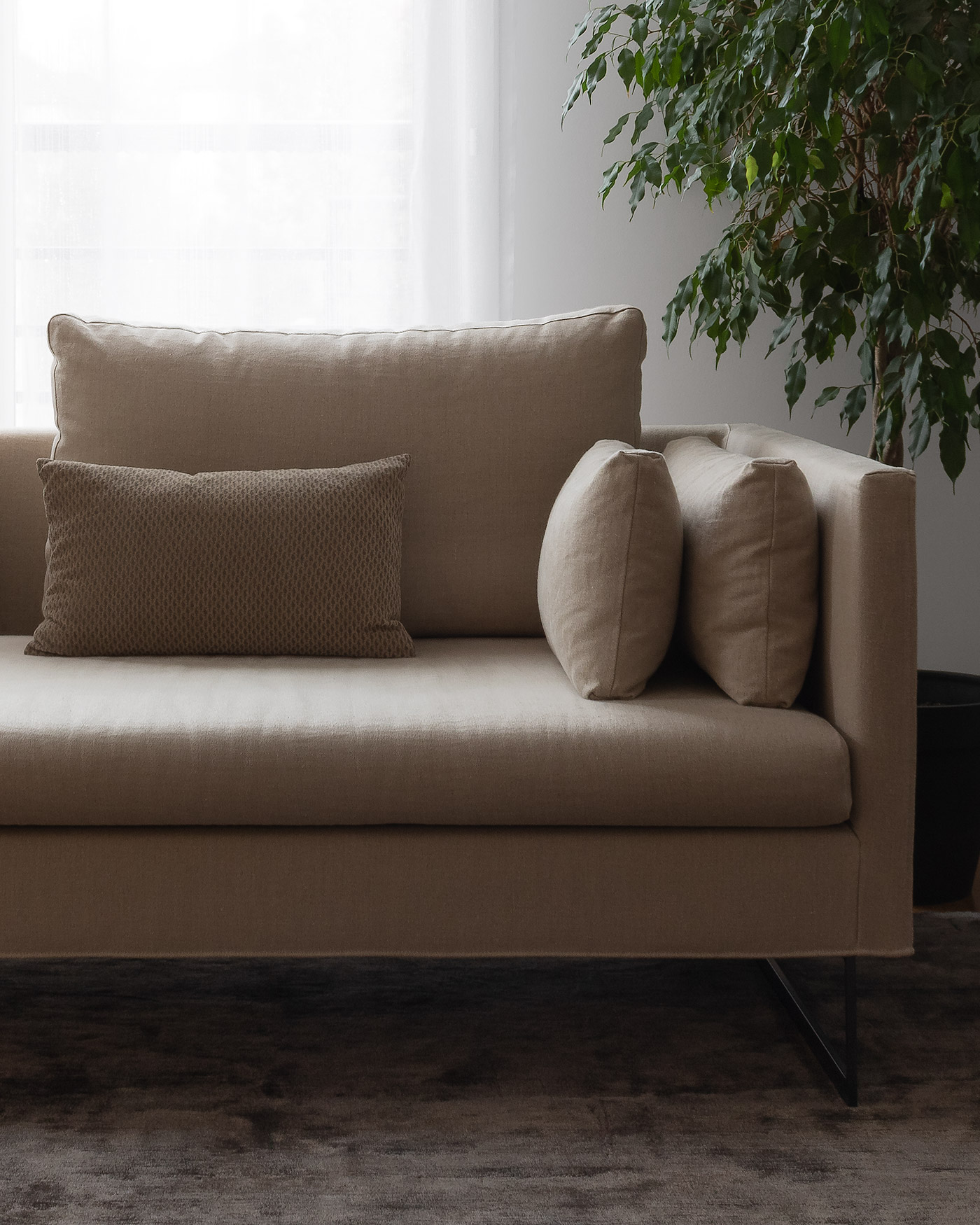 modern neutral sofa on grey brown viscose luxury rug
