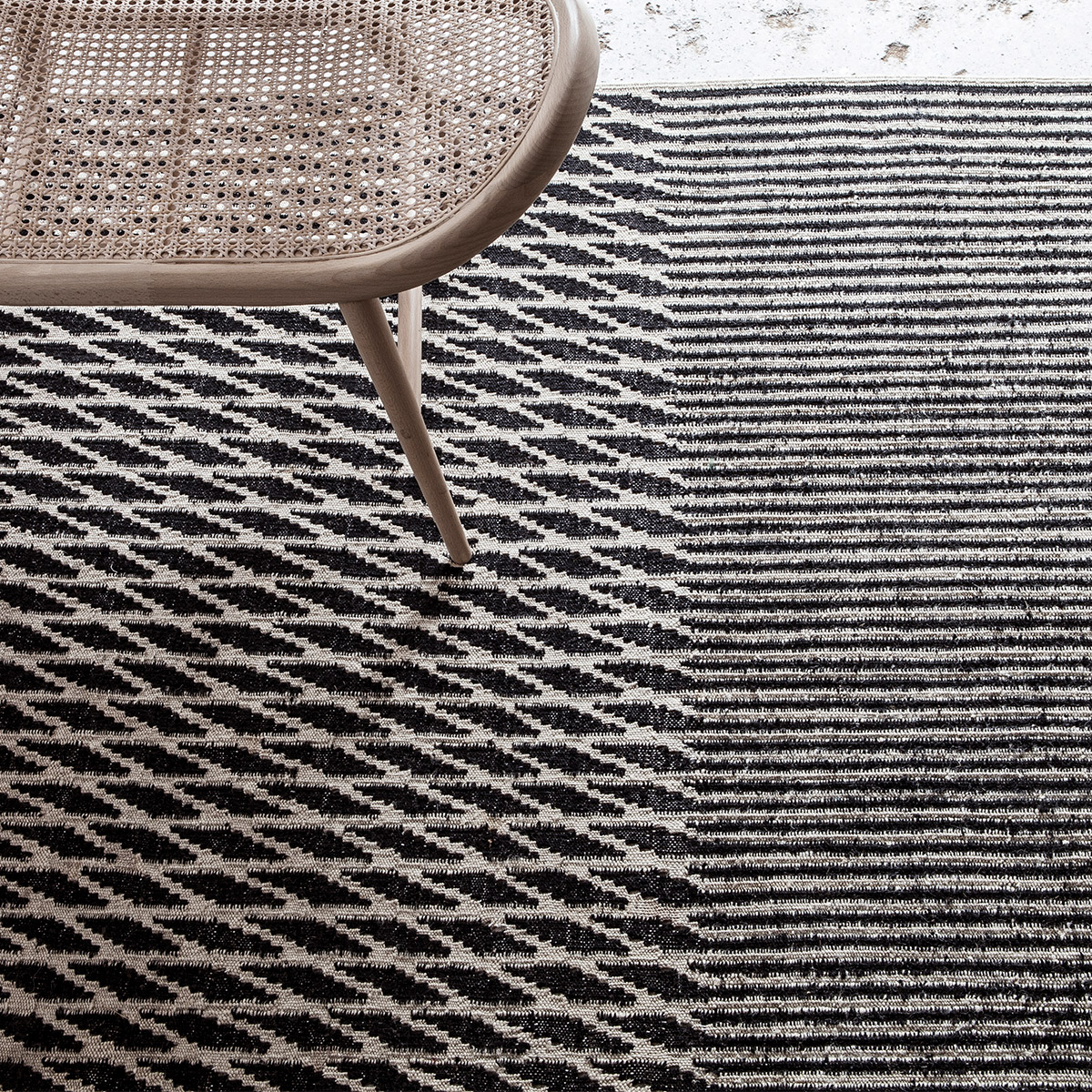 black and white geometric rug with Japanese light oak chair