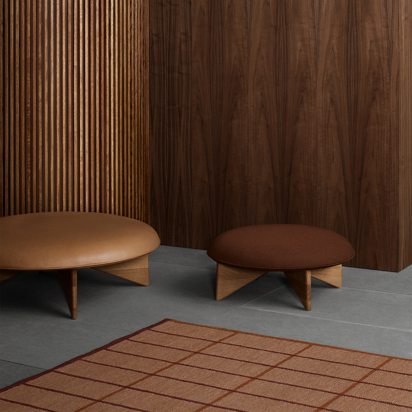 tan geometric wool rug with modern Scandinavian dark wooden stools