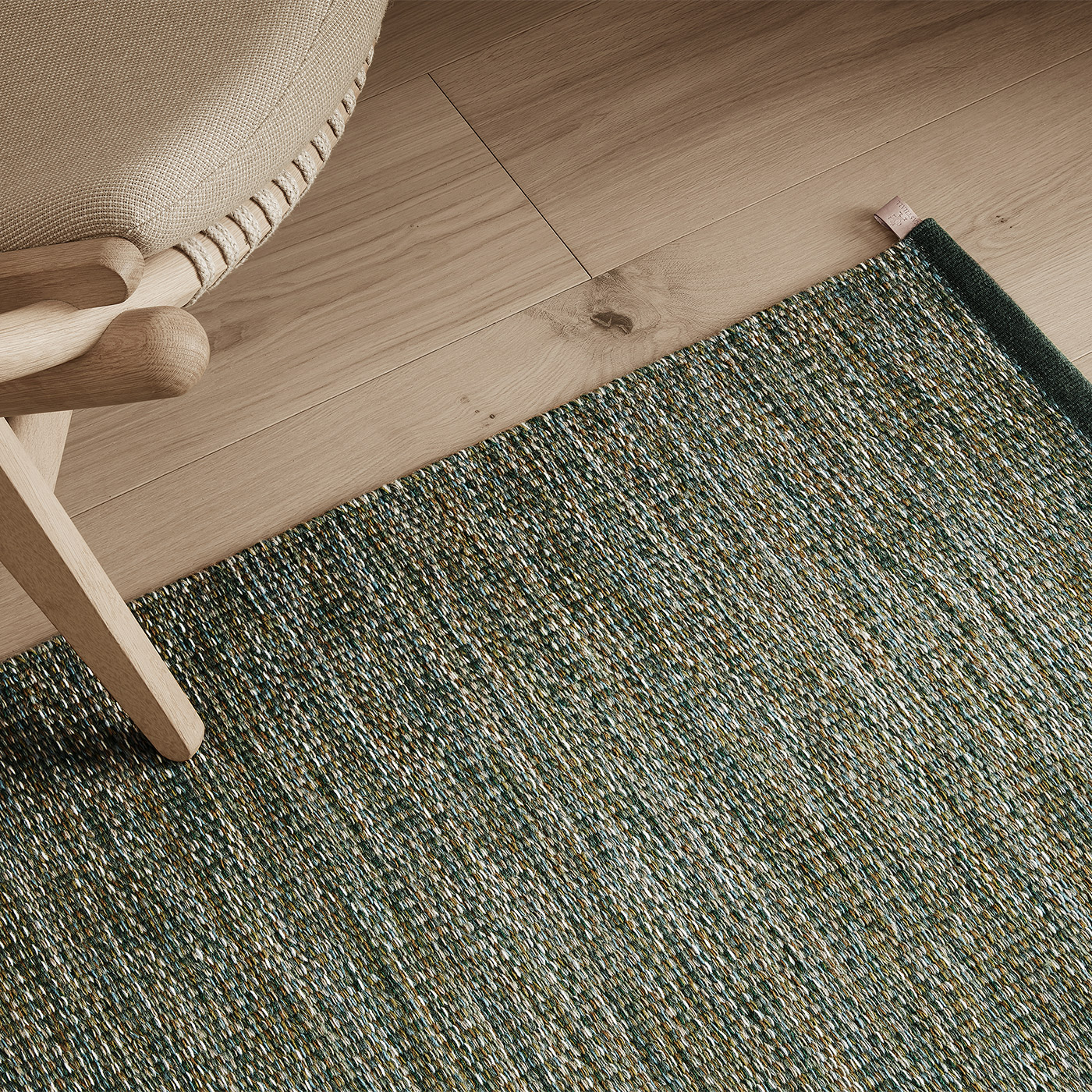 modern green marl rug with Scandinavian light oak armchair