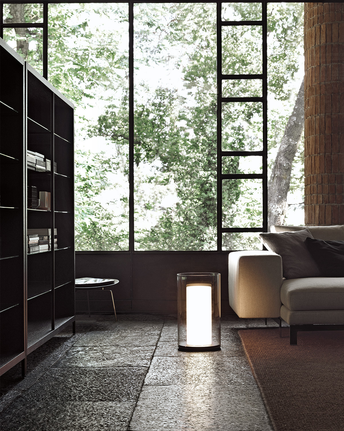 modern Italian interior with floor to ceiling windows, minimal sofa and bookshelves and floor lamp