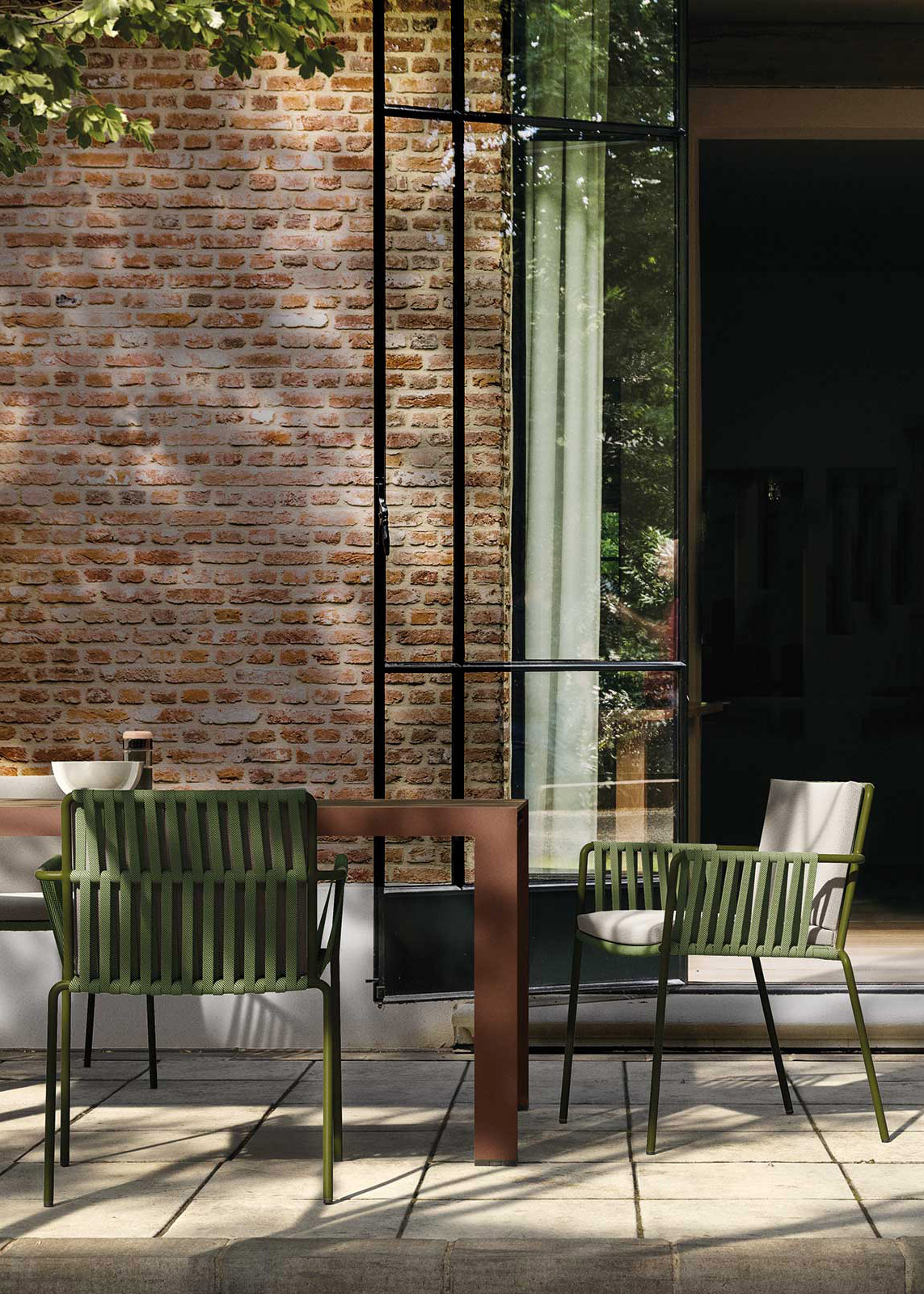 Landscape outdoor dining table in aluminium with fabric cord outdoor dining chair in Townhouse garden