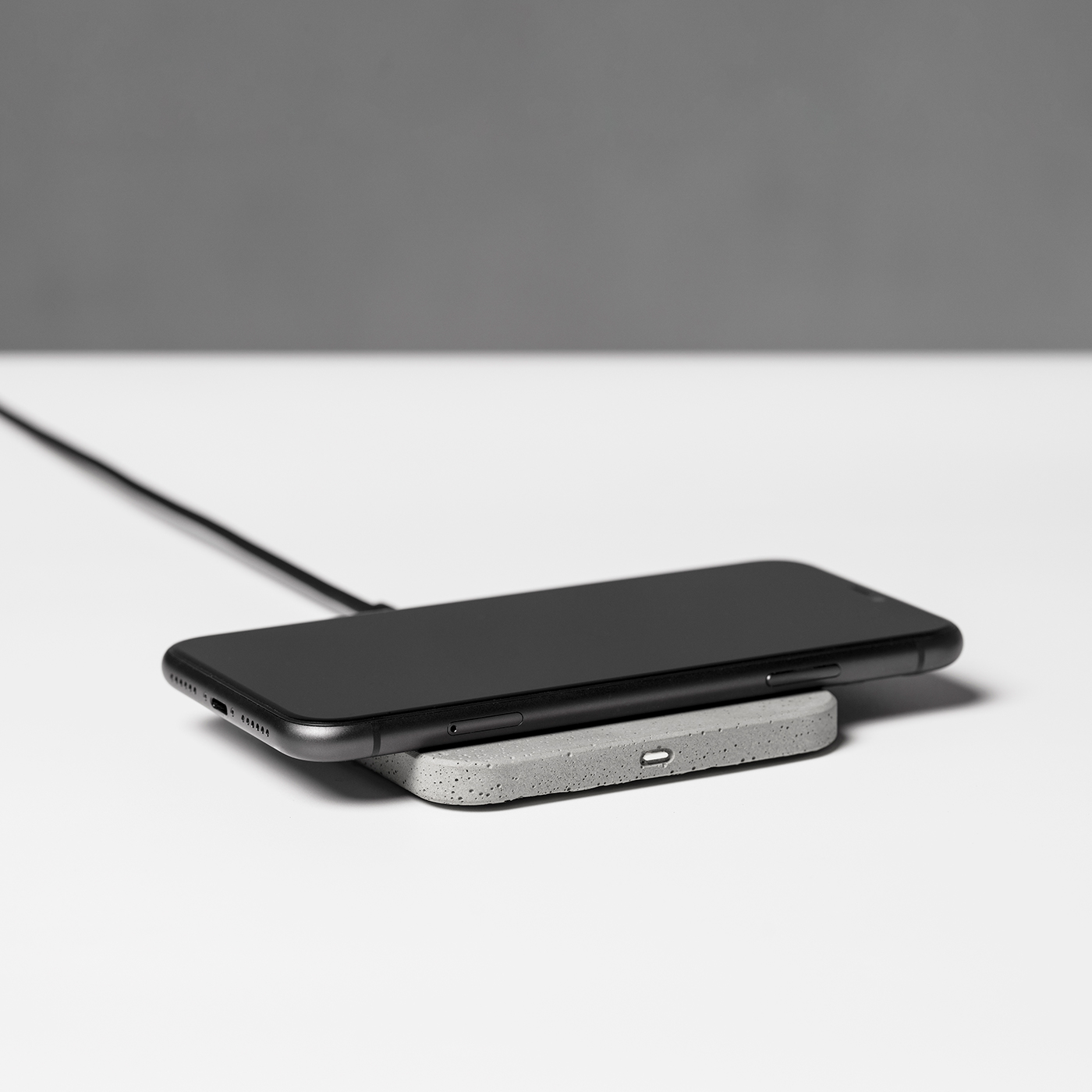 integrated concrete wireless charging pad with iPhone