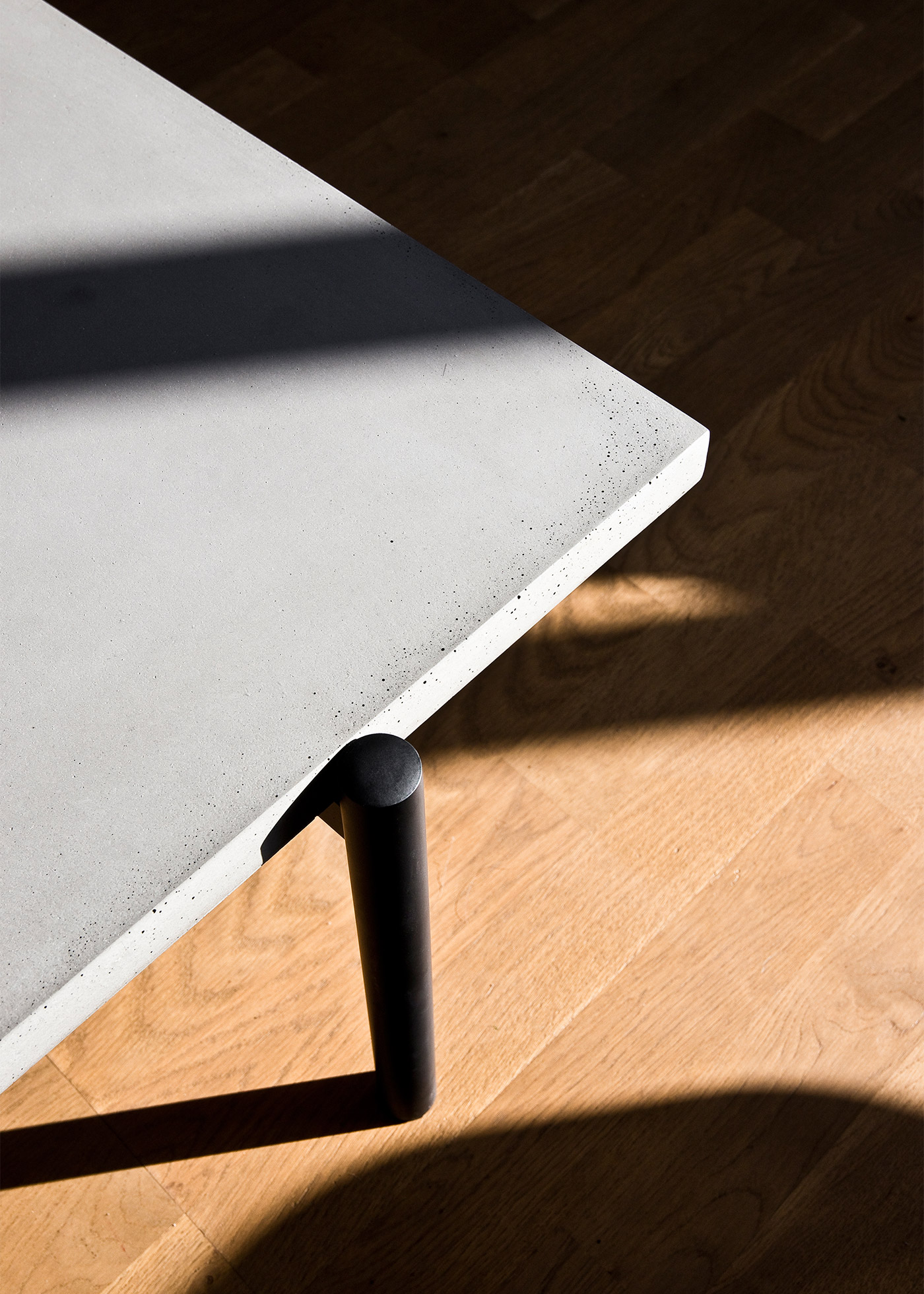 concrete and black metal coffee table in sunlight