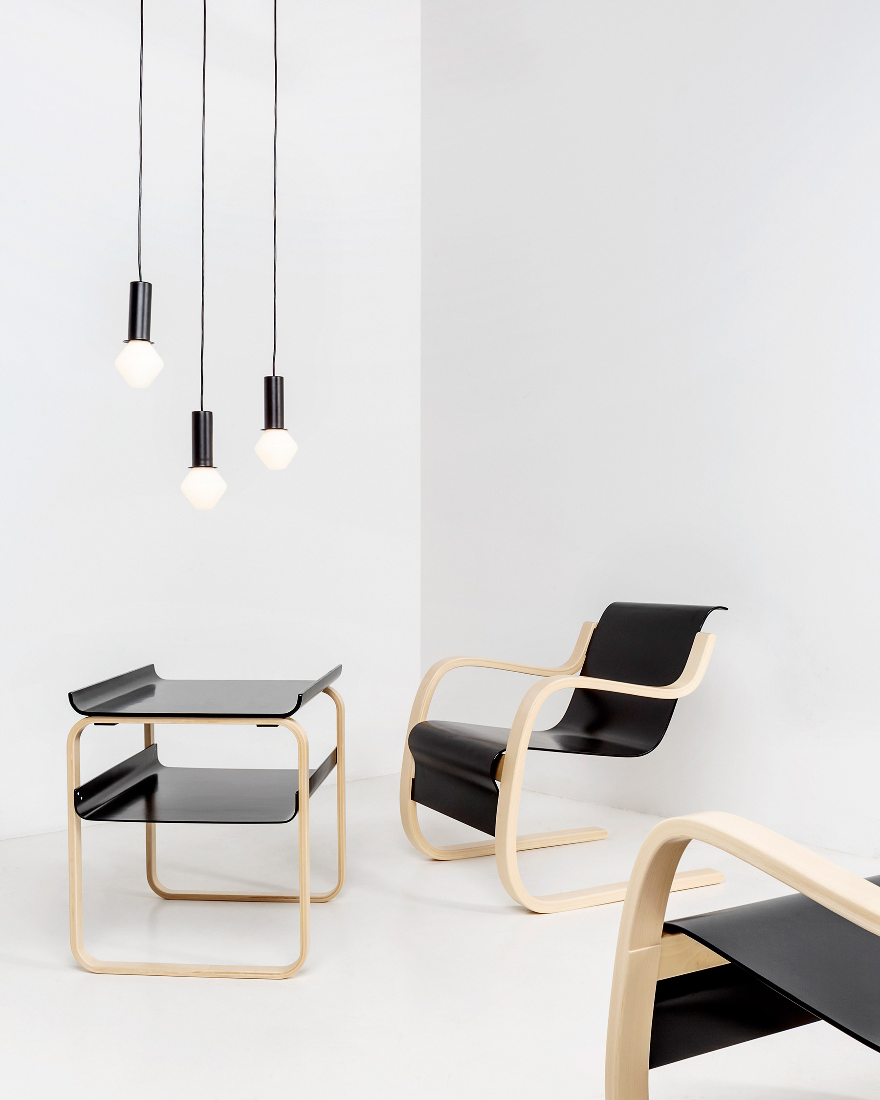 Modernist birch plywood side table and armchair designed by Alvar Aalto