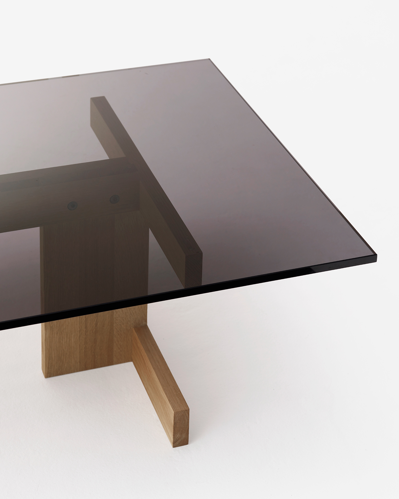 Smoked glass table top on solid geometric oak legs