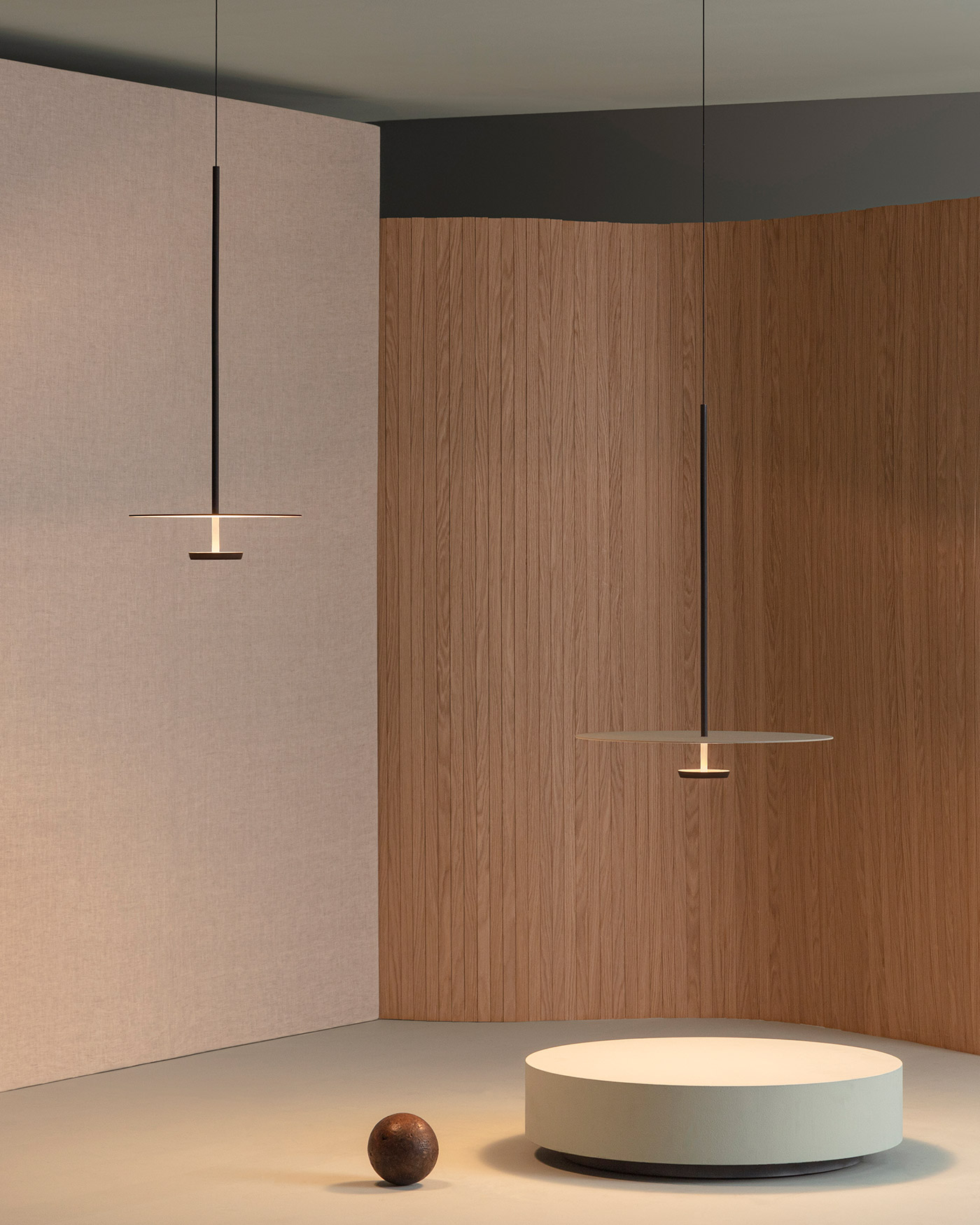 Flat hanging lights against fabric and wood screens