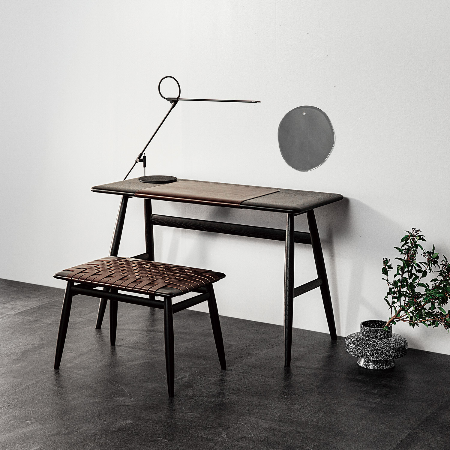Modern minimal black wooden desk and stool, concrete floor