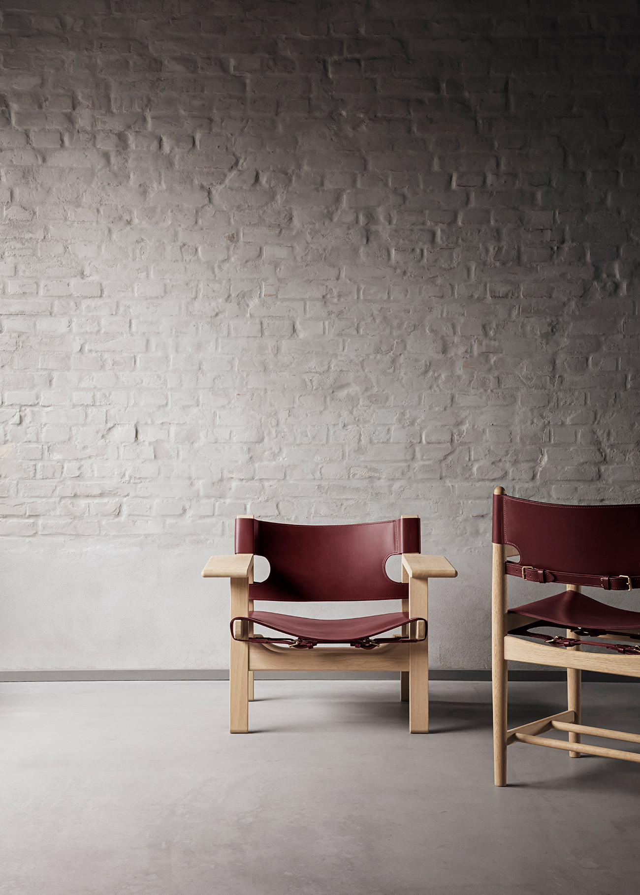 Modern wooden and leather armchair on concrete floor