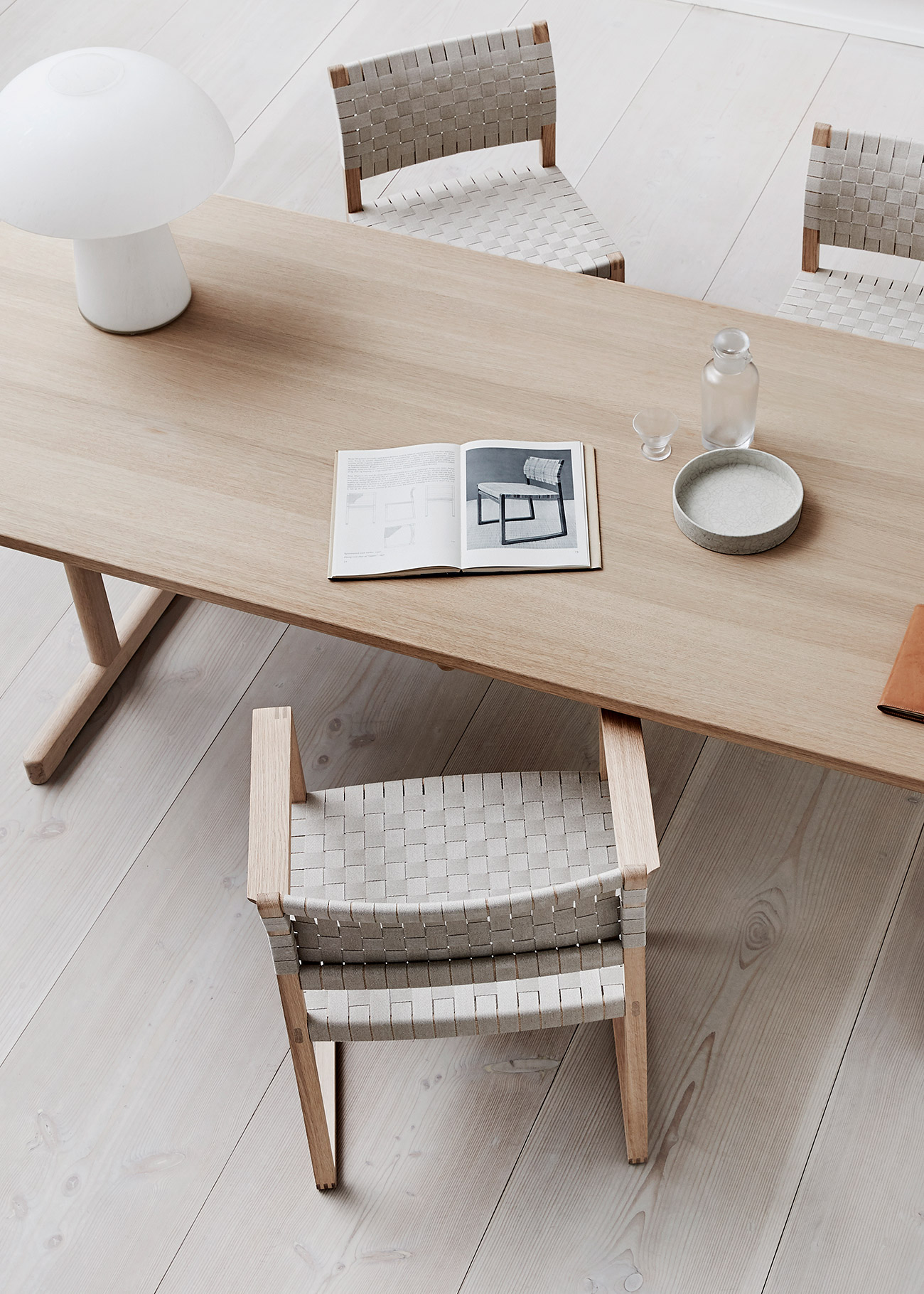 Modern minimal wooden dining table, chairs and white lamp