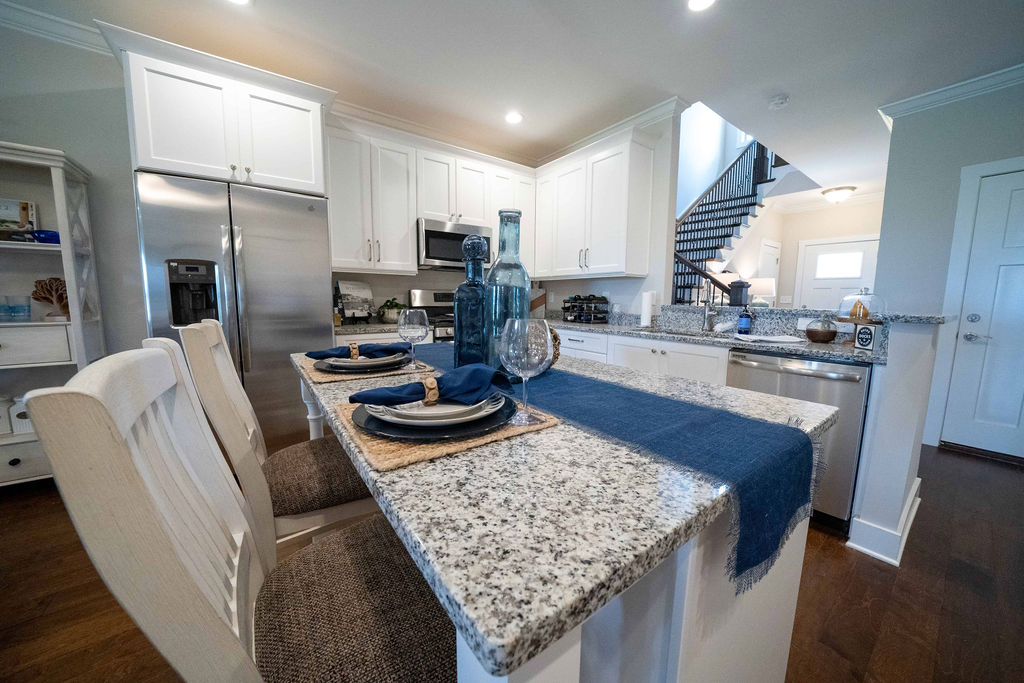 Kitchen bar counter with dinner plates and chairs