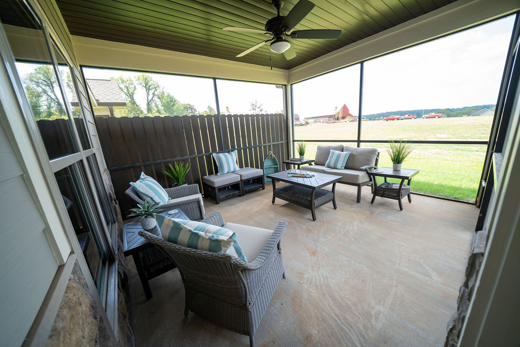 Screened-in and fenced back patio of town home