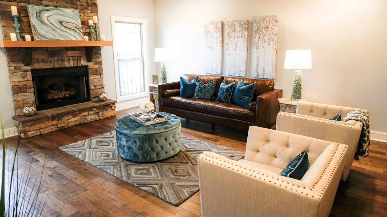 Living room with couch, two chairs, fireplace, and decorations