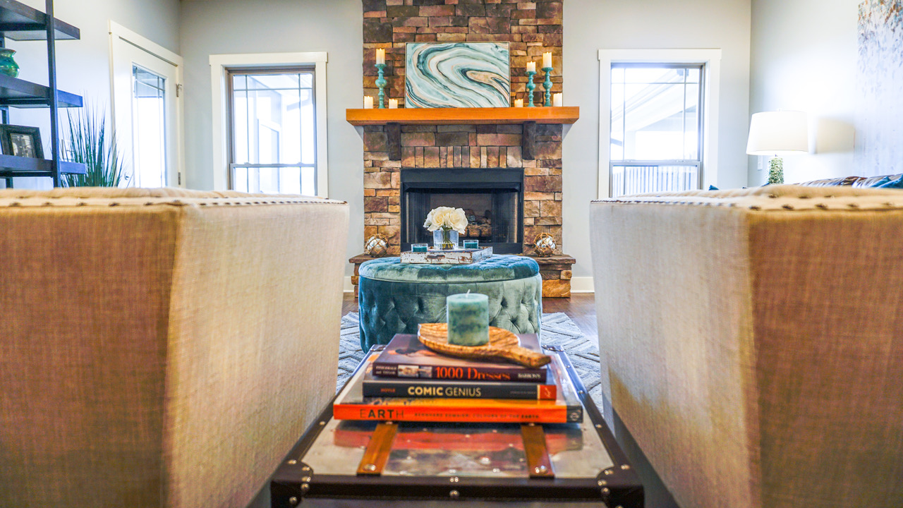 View of fireplace and books between two chairs