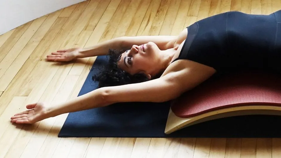 Head and shoulder image of pilates pose on matt.