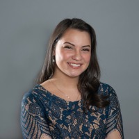 Jaclyn Tryon is depicted in a photo against a grey background 