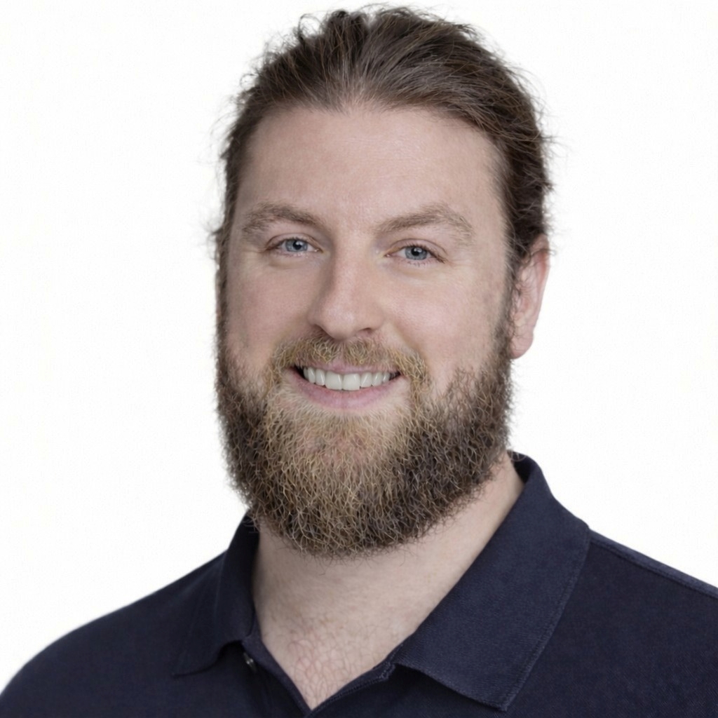 A photo of Yan in a blue polo shirt in front of a white background