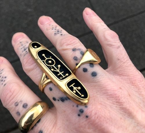 A brass ring in the shape of a reliquary