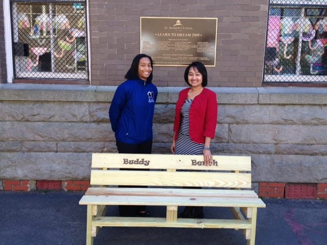 TDT caseworker Brianna Dillard-Dula presents Buddy Bench to St. Andrews Episcopal head of School, Dr. Cyndy Weldon-Lassiter.