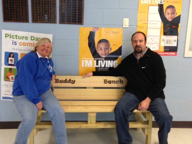 Pam Pitchford joins Principal Russ Macomber on George Watkins Elementary's new Buddy Bench!