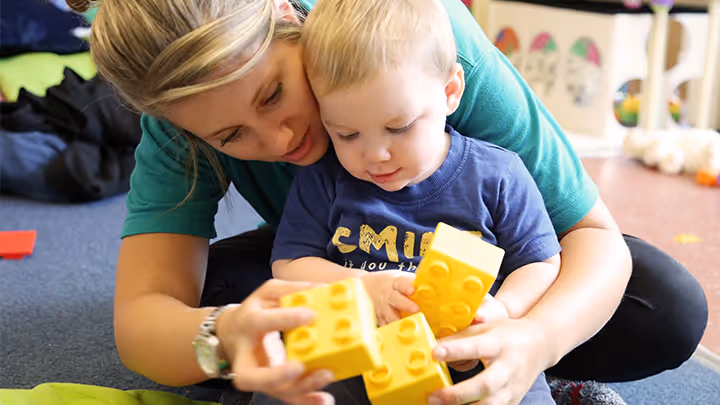 photo of a child playing with lego