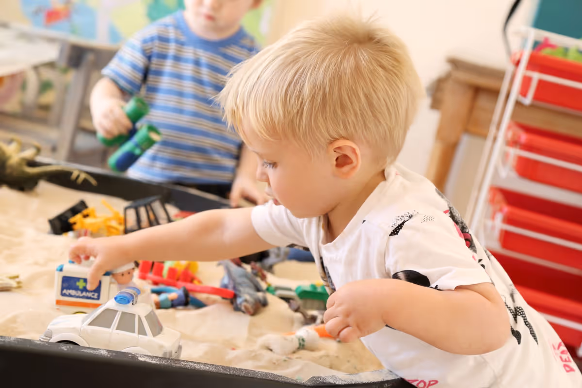 photo of a child plaing in a sandpit