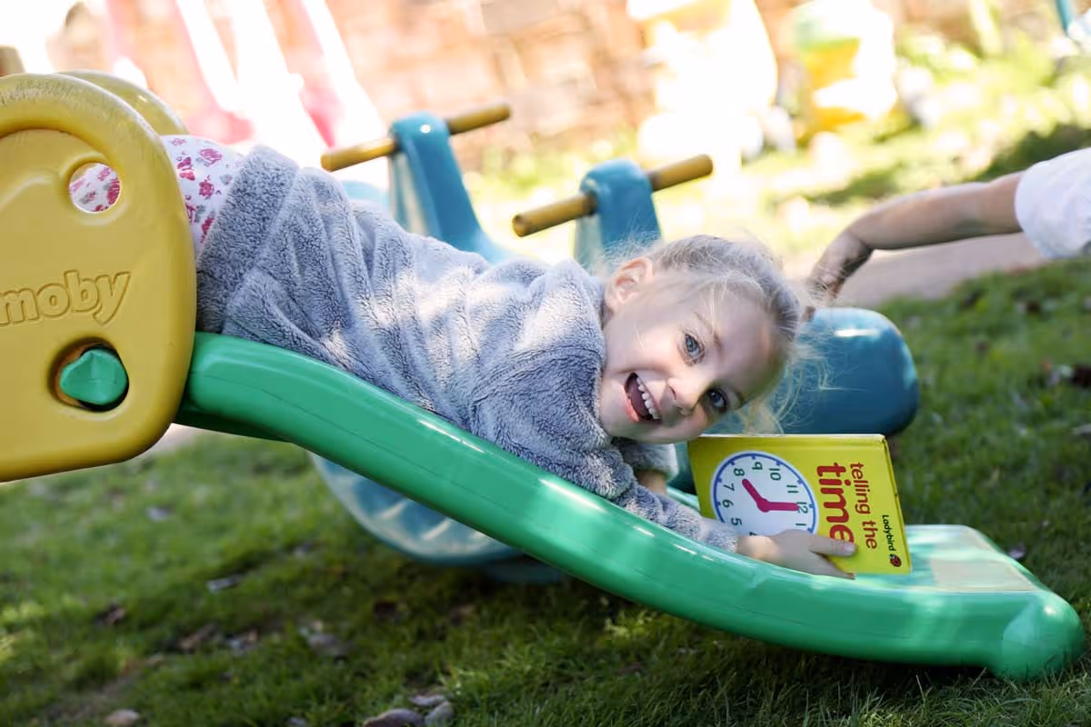 photo of a child on a slide